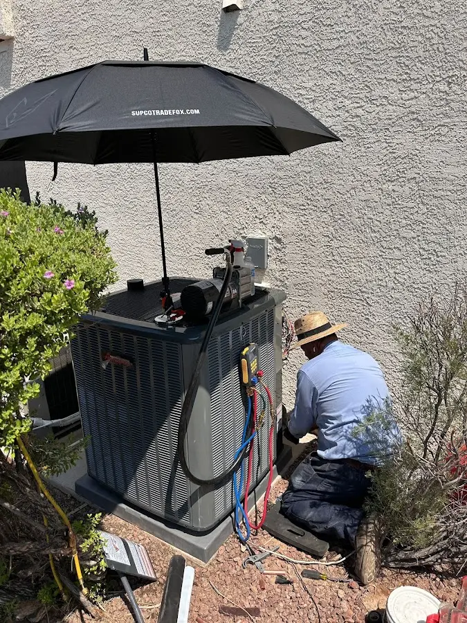 HVAC technician performing outdoor AC maintenance in New Freedom